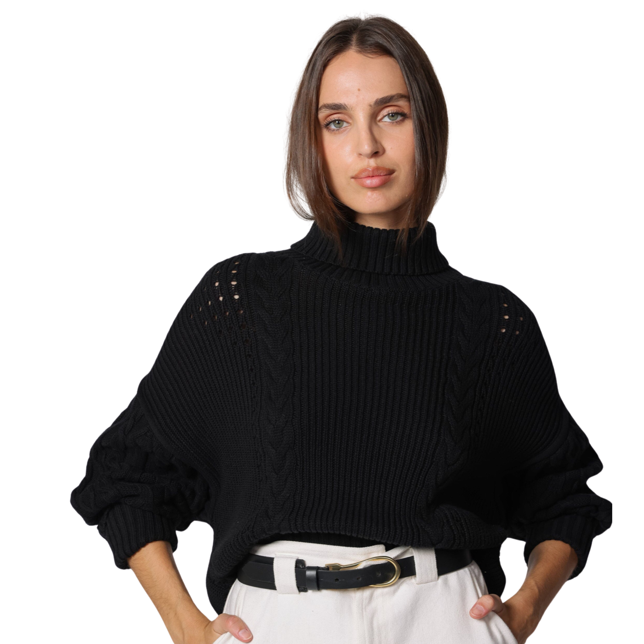 Woman wearing a black sweater with shoulder embellishments on a white background